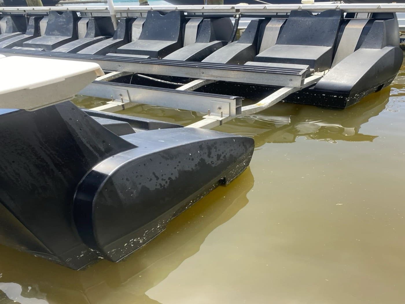 Floating jet ski dock on a canal, cleaned of marine growth
