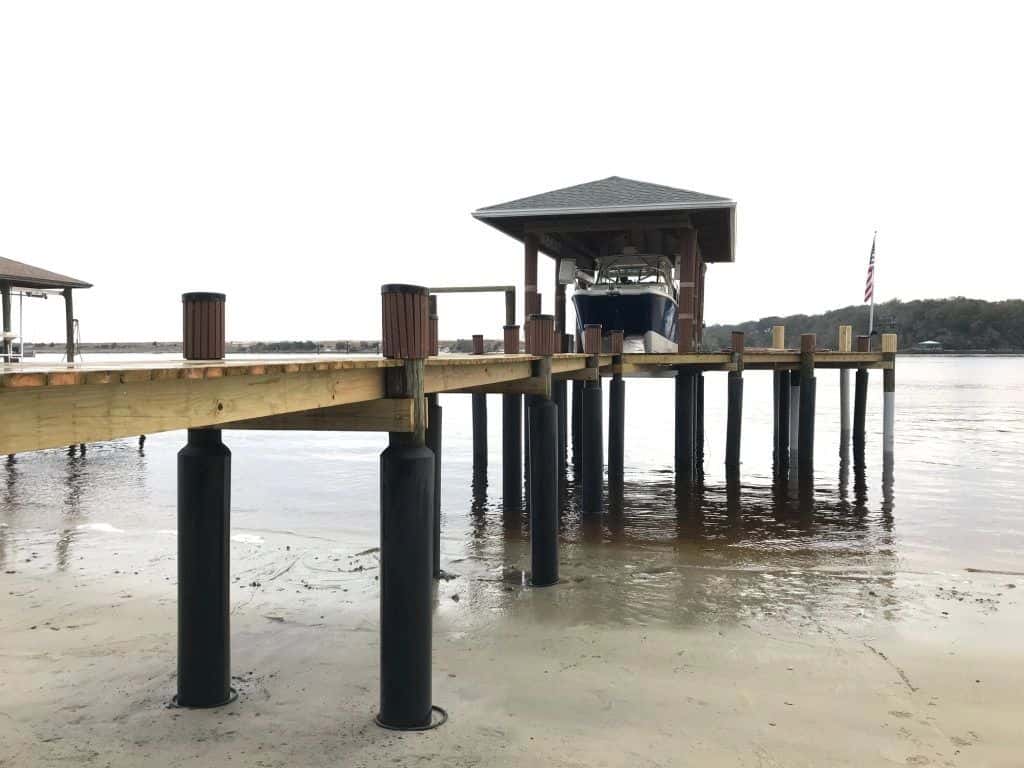 Dock and boathouse with pilings protected by Snap Jackets