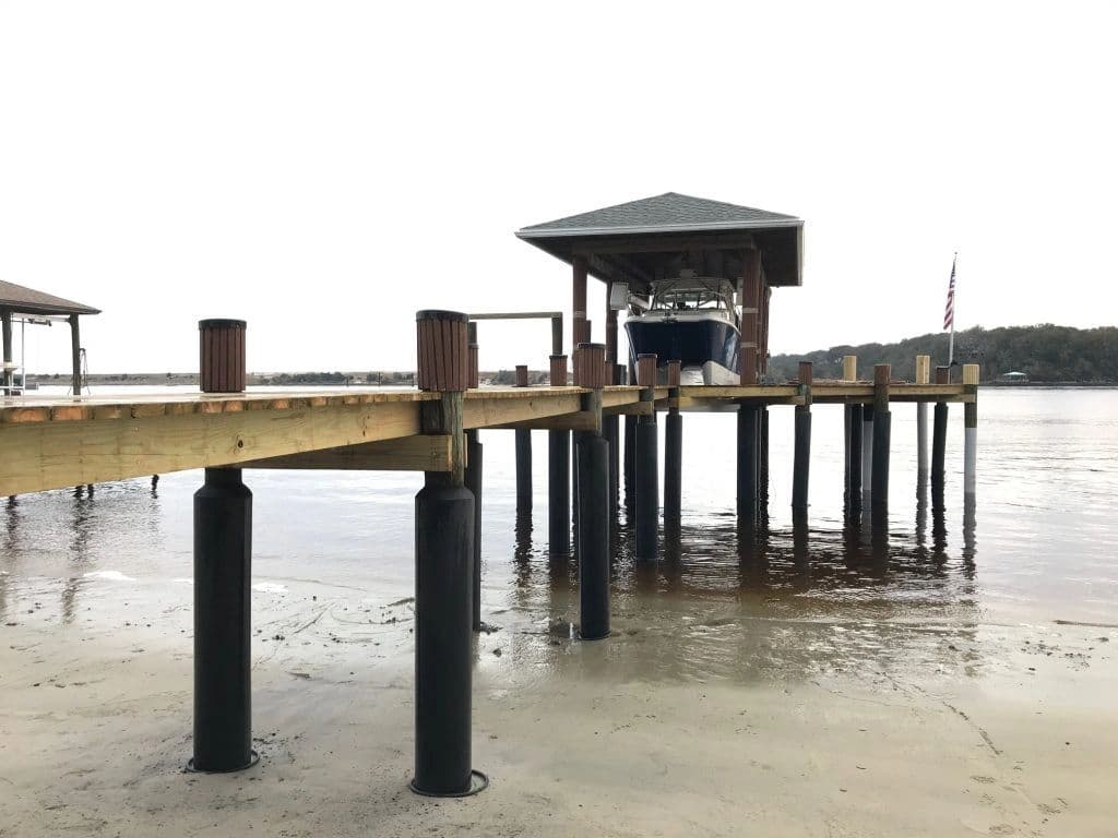 Dock and boathouse with pilings protected by Snap Jackets