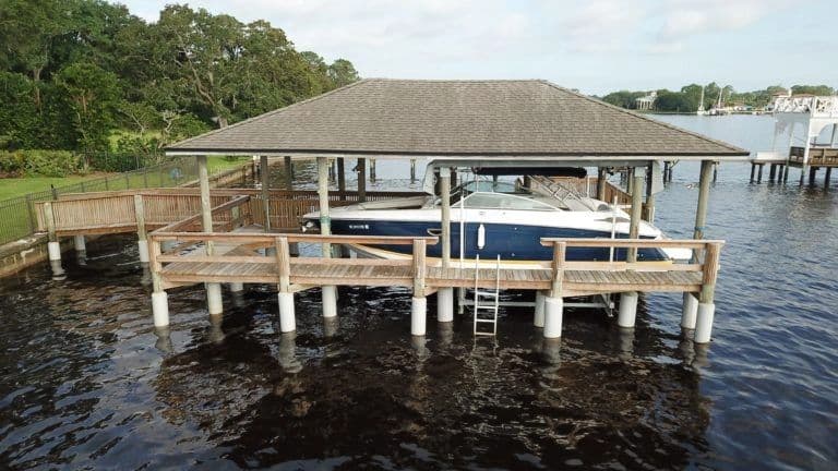 Covered boat lift and dock with Snap Jacket piling sleeves