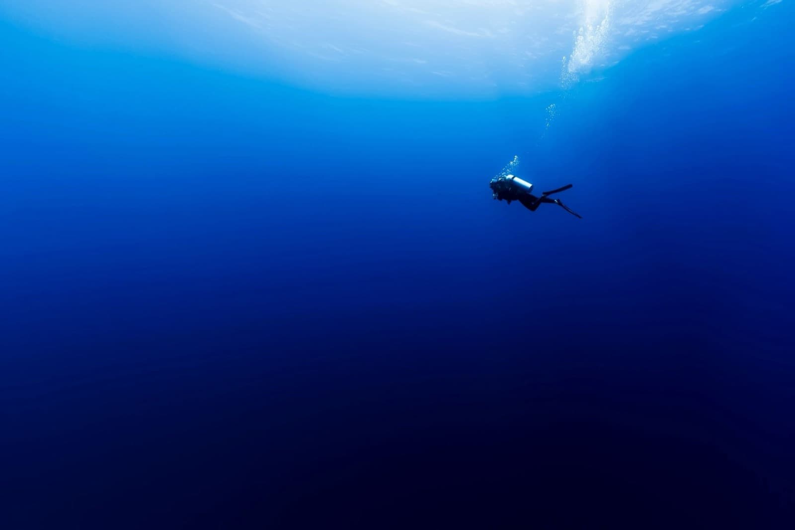 Scuba diver in deep blue open water