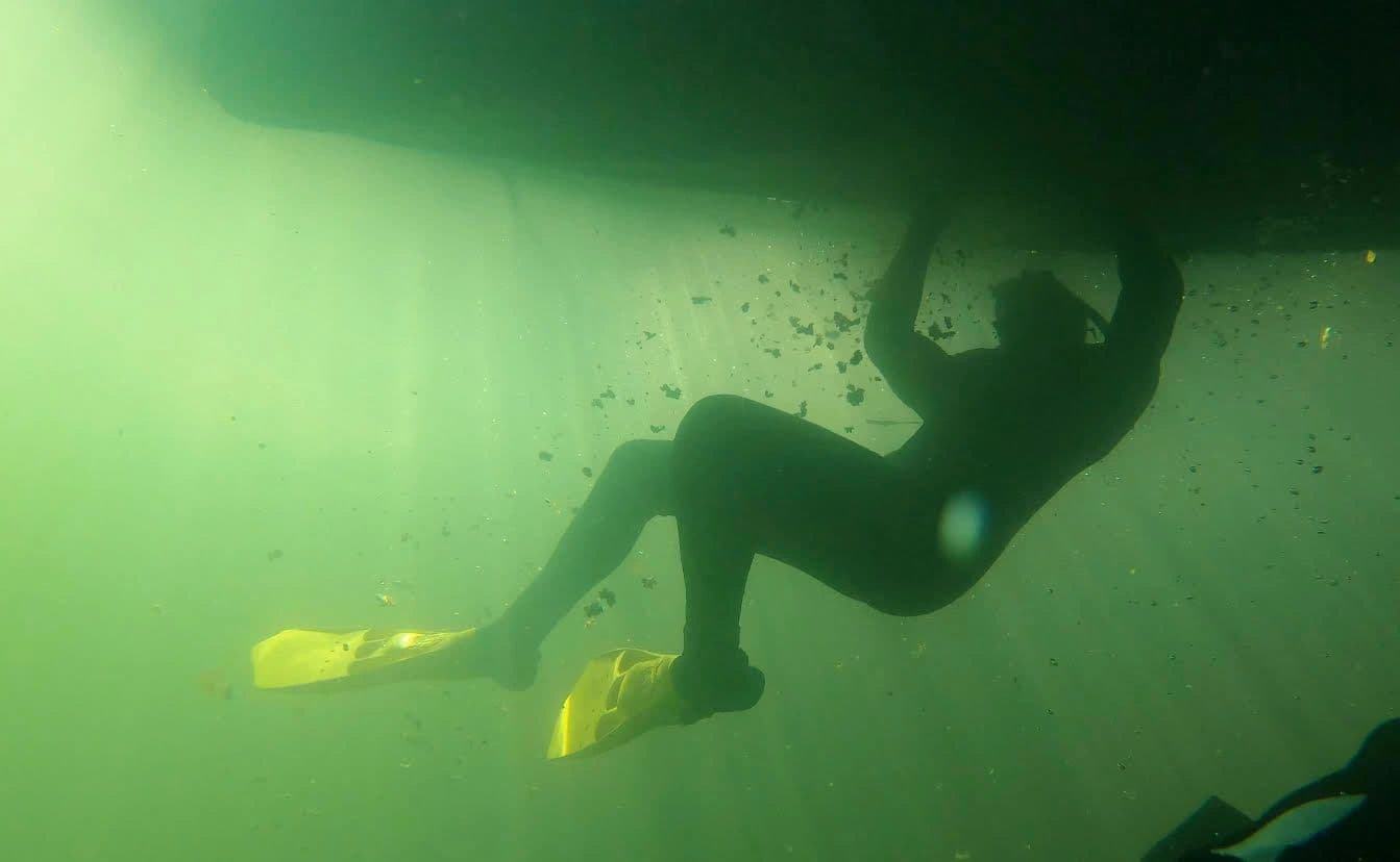Barnacle Doctor diver cleaning the underside of a boat hull